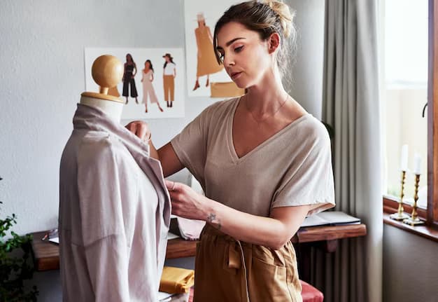 Girl stylist creates a dress on a mannequin