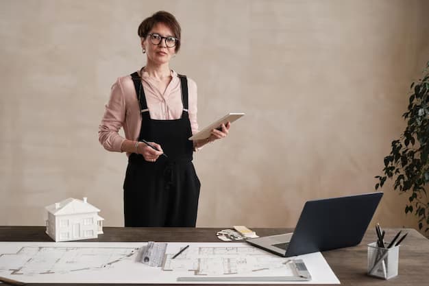 A woman with a tablet in her hands stands in her studio